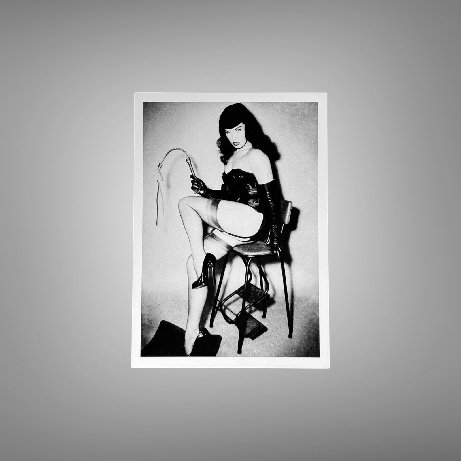 Pin-Up & Glamour Dark-haired Seated Whip Prop Pose with Polished Black-and-white Contrast 5x7 Photo Print